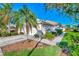 Two-car garage, mature landscaping, and a paved driveway at 4245 Whispering Oaks Dr, North Port, FL 34287