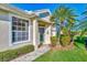 Front entry with landscaping and a paved walkway at 4245 Whispering Oaks Dr, North Port, FL 34287