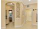 Bright hallway with decorative arch and tile flooring at 4245 Whispering Oaks Dr, North Port, FL 34287