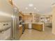 Modern kitchen with stainless steel appliances and light wood cabinets at 4245 Whispering Oaks Dr, North Port, FL 34287