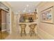 Kitchen features a breakfast bar and view into the dining area at 4245 Whispering Oaks Dr, North Port, FL 34287