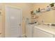 Laundry room with washer, dryer, and shelving at 4245 Whispering Oaks Dr, North Port, FL 34287