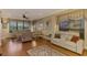Relaxing living room with hardwood floors, large windows, and comfortable seating at 4245 Whispering Oaks Dr, North Port, FL 34287