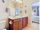 Double vanity bathroom with a toilet and access to bedroom at 4334 Lenox Blvd, Venice, FL 34293