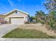 Tan house with a two-car garage and nicely landscaped front at 4334 Lenox Blvd, Venice, FL 34293