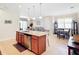 Open concept kitchen with island, dining area, and living room view at 4334 Lenox Blvd, Venice, FL 34293