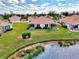 Aerial view of a beautiful home and community by the lake at 4980 Whispering Oaks Dr, North Port, FL 34287