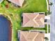 Bird's eye view of home near a lake with community in background at 4980 Whispering Oaks Dr, North Port, FL 34287