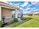 Landscaped backyard with a patio and lake view at 4980 Whispering Oaks Dr, North Port, FL 34287