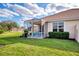 Screened patio with table and chairs, overlooking a lush green lawn at 4980 Whispering Oaks Dr, North Port, FL 34287