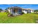 Well-maintained backyard features a large screened patio and lush lawn at 4980 Whispering Oaks Dr, North Port, FL 34287