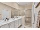 Bathroom featuring double sinks and a walk-in shower with glass doors at 4980 Whispering Oaks Dr, North Port, FL 34287