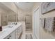 Bathroom featuring double sinks and a walk-in shower with glass doors at 4980 Whispering Oaks Dr, North Port, FL 34287