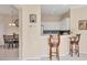 Charming kitchen with white cabinets and a convenient breakfast bar overlooking the dining area at 4980 Whispering Oaks Dr, North Port, FL 34287