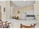 Well-lit kitchen with white cabinetry and a breakfast bar, connecting to the adjacent dining area at 4980 Whispering Oaks Dr, North Port, FL 34287