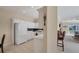 Bright, all-white kitchen featuring modern appliances and an open layout to dining and living areas at 4980 Whispering Oaks Dr, North Port, FL 34287