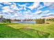 Tranquil lake view with fountain, lush landscaping, and homes in the background at 4980 Whispering Oaks Dr, North Port, FL 34287