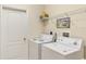 Convenient laundry room with washer, dryer, and extra storage at 4980 Whispering Oaks Dr, North Port, FL 34287