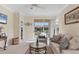 Inviting living room featuring a sliding glass door and neutral decor, ideal for relaxation at 4980 Whispering Oaks Dr, North Port, FL 34287