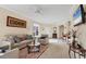 Open living room with views of the entryway and kitchen, filled with natural light at 4980 Whispering Oaks Dr, North Port, FL 34287