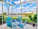 Screened-in patio overlooking a serene lake view at 4980 Whispering Oaks Dr, North Port, FL 34287