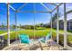 Screened patio with lake views provides an outdoor retreat at 4980 Whispering Oaks Dr, North Port, FL 34287