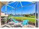 Inviting screened-in patio offering serene lake views and outdoor enjoyment at 4980 Whispering Oaks Dr, North Port, FL 34287