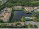 Aerial view of a community with lake, pool, and multiple buildings at 500 San Lino Cir # 521, Venice, FL 34292