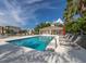 Relaxing community pool with plenty of lounge chairs and red umbrellas at 500 San Lino Cir # 521, Venice, FL 34292