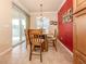 Bright dining area with wood table and chairs, near sliding doors to balcony at 500 San Lino Cir # 521, Venice, FL 34292