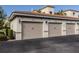 Three-car garage with beige doors and exterior lighting at 500 San Lino Cir # 521, Venice, FL 34292