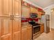 Well-equipped kitchen with stainless steel appliances and wood cabinets at 500 San Lino Cir # 521, Venice, FL 34292
