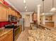 Kitchen with granite countertops, stainless steel appliances, and wood cabinets at 500 San Lino Cir # 521, Venice, FL 34292