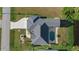 Drone shot of the house showing the spacious roof, manicured lawn, and proximity to neighboring greenery at 52 Fairway Rd, Rotonda West, FL 33947