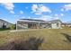 Expansive screened-in lanai, perfect for outdoor relaxation, with a view of the grassy backyard at 52 Fairway Rd, Rotonda West, FL 33947
