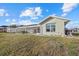 Spacious backyard with a screened patio and well-maintained lawn area for outdoor enjoyment at 52 Fairway Rd, Rotonda West, FL 33947
