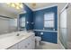 Bright bathroom featuring a single sink vanity with ample counter space and a framed mirror at 52 Fairway Rd, Rotonda West, FL 33947