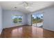 Light bedroom with wood floors, a ceiling fan, and sliding glass doors offering a scenic view at 52 Fairway Rd, Rotonda West, FL 33947