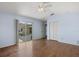 Bedroom with hardwood floors, ceiling fan and sliding glass door to the pool at 52 Fairway Rd, Rotonda West, FL 33947