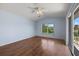 Well-lit bedroom features hardwood floors, a ceiling fan, and a sliding glass door at 52 Fairway Rd, Rotonda West, FL 33947