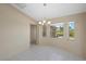 Inviting dining room with a chandelier, large window with outside views, and tile flooring at 52 Fairway Rd, Rotonda West, FL 33947