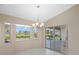 Bright dining area featuring a chandelier, large window, and sliding doors to the pool at 52 Fairway Rd, Rotonda West, FL 33947
