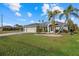 Charming home featuring a well-manicured lawn, lush landscaping, and a welcoming entrance at 52 Fairway Rd, Rotonda West, FL 33947