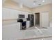 Well-lit kitchen featuring stainless steel appliances, white cabinets, and tile countertops at 52 Fairway Rd, Rotonda West, FL 33947