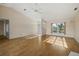 Open living room with hardwood floors and access to the entryway at 52 Fairway Rd, Rotonda West, FL 33947
