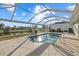 Sparkling pool surrounded by a stone patio and screen enclosure at 52 Fairway Rd, Rotonda West, FL 33947