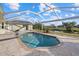 Enjoy the outdoors with this screened-in pool, complemented by a spacious patio area, and serene view at 52 Fairway Rd, Rotonda West, FL 33947