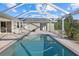 Relax by the pool with this backyard featuring a screened-in pool, deck, and a tranquil outdoor space at 52 Fairway Rd, Rotonda West, FL 33947