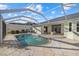 Enjoy the outdoors with this screened-in pool, complemented by a spacious patio area, and serene view at 52 Fairway Rd, Rotonda West, FL 33947