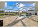 Sparkling in-ground pool with a screened enclosure and a beautiful view of the pond at 52 Fairway Rd, Rotonda West, FL 33947